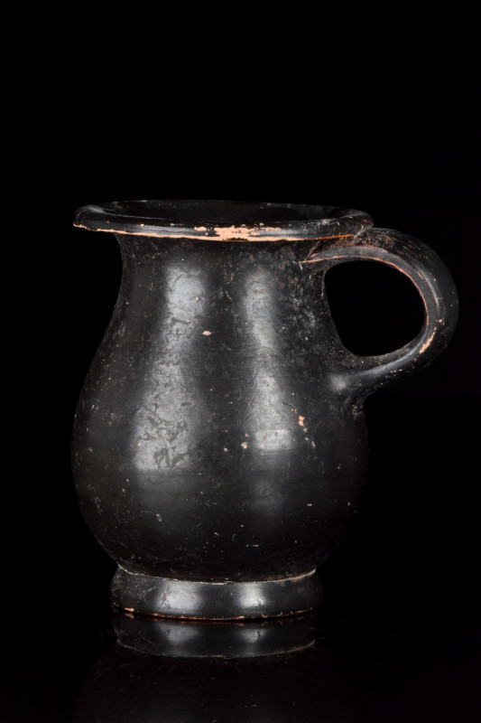 GREEK APULIAN BLACK GLAZED POTTERY ONE-HANDLED CUP
Ca. 400 BC. 
A lovely black...