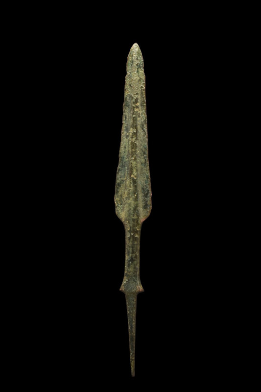 ANCIENT BRONZE LONG SPEARHEAD
Ca. 1200-700 BC. 
A long bronze spear with an el...