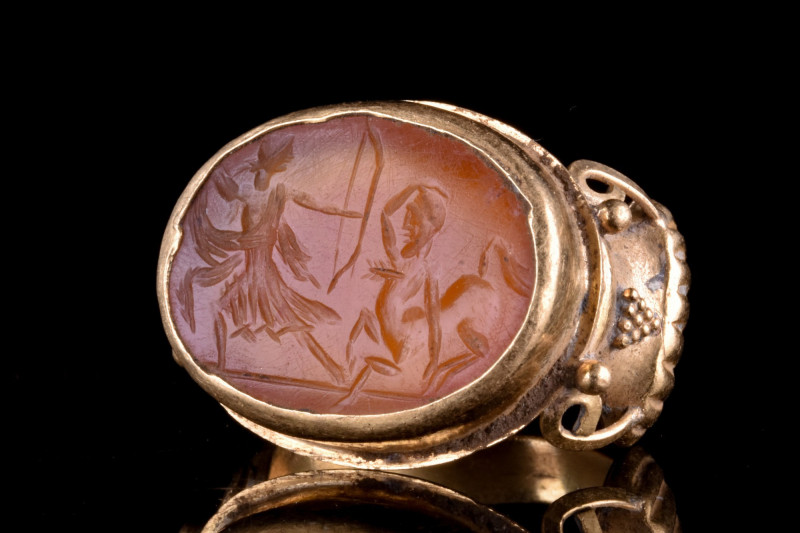 ROMAN INTAGLIO WITH AMAZON FIGHTING A CENTAUR IN GOLD RING
Ca. 200-300 AD. 
A ...