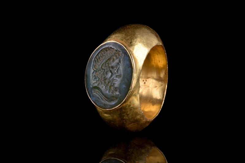 ROMAN GOLD RING WITH JUPITER GREEN INTAGLIO
Ca. 100-300 AD. 
The ring features...