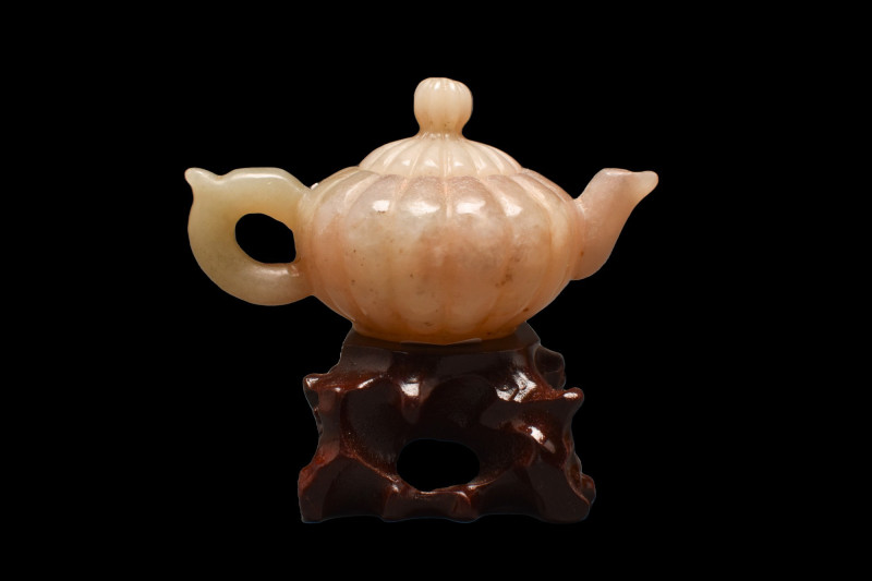 CHINESE JADE TEAPOT
. 
A jade-carved teapot with a domed lid with a knob. It c...