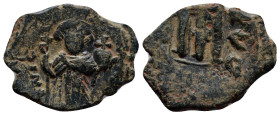 Arab-Byzantine, c. 660s-680s. Æ Fals (20mm, 4.6 g), Emperor standing facing, holding long cross and globus cruciger. R/ Cursive M; cross above; ANNO t...