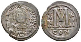 JUSTINIAN I.(527-565).Constantinople.Follis.

Obv : D N IVSTINIANVS P P AVC.
Helmeted, cuirassed bust facing, holding cross on globe and shield with h...