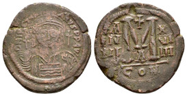 JUSTINIAN I.(527-565).Constantinople.Follis.

Obv : D N IVSTINIANVS P P AVC.
Helmeted, cuirassed bust facing, holding cross on globe and shield with h...