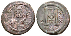 JUSTINIAN I.(527-565). Antioch.Follis.

Obv: D N IVSTINIANVS P P AVG.
Helmeted and cuirassed bust facing, holding globus cruciger and shield; cross to...