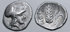 Lucania, Metapontion AR Diobol. Circa 325-275 BC. Head of Athena to right, wearing Corinthian helmet / Ear of barley with leaf to right; META upwards ...