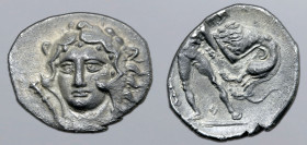 Calabria, Tarentum AR Diobol. Circa 325-280 BC. Head of Herakles facing slightly to left, wearing lion skin headdress; club to left / Herakles standin...
