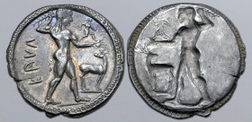 Bruttium, Kaulonia AR Stater. Circa 525-500 BC. Nude Apollo walking to right, holding laurel branch, small daimon running to right on extended arm, ho...