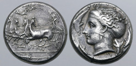 Sicily, Syracuse AR Tetradrachm. Time of Dionysios I, circa 405-400 BC. Charioteer, holding reins and kentron, driving fast quadriga to left; Nike abo...