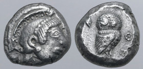 Attica, Athens AR Tetradrachm. Circa 485-480 BC. Archaic head of Athena to right, wearing crested helmet decorated with chevron and dot pattern, and r...