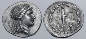Aiolis, Myrina AR Tetradrachm. Circa 155-145 BC. Stephanophoric type. Laureate head of Apollo to right / Apollo Grynios standing to right, holding phi...