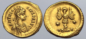 Theodosius II AV Tremissis. Constantinople, AD 402-450. D N THEODOSIVS P F AVG, pearl-diademed, draped, and cuirassed bust to right / Trophy with shie...
