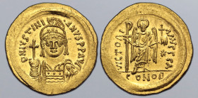 Justinian I AV Solidus. Constantinople, AD 545-565. D N IVSTINIANVS P P AVC, helmeted and cuirassed bust facing, holding globus cruciger and shield de...