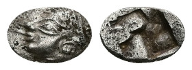 Ionia, Kolophon. AR Obol, 0.40 g 8.83 mm. Late 6th century BC. 
Obv: Archaic male head (of Apollo?) left.
Rev: Quadripartite incuse square.
Ref: SNG K...