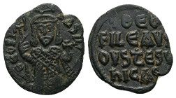 Theophilus, AD 830-842. AE, Follis. 2.59 g. 21.12 mm. Constantinople.
Obv: ΘEOFIL-bASIL. Crowned, three-quarter length figure of Theophilus facing, pe...