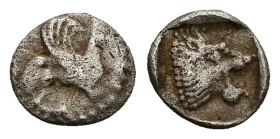 Troas, Assos. AR Hemiobol, 0.54 g 8.33 mm. Circa 500-450 BC.
Obv: Griffin seated to right, raising forepaw
Rev: Head of roaring lion to right within s...