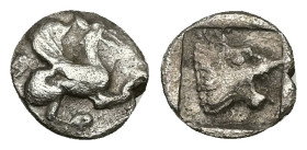 Troas, Assos. AR Hemiobol, 0.57 g 9.42 mm. Circa 500-450 BC.
Obv: Griffin seated to right, raising forepaw
Rev: Head of roaring lion to right within s...