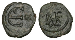 Justin II, AD 565-578. AE, Decanummium. 1.84 g. 15.47 mm. Constantinople.
Obv: Justin II monogram.
Rev: Large Є, officina (N) letter to right. 
Ref: S...