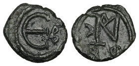 Justin II, AD 565-578. AE, Decanummium. 1.86 g. 15.44 mm. Constantinople.
Obv: Justin II monogram.
Rev: Large Є, officina (B) letter to right. 
Ref: S...