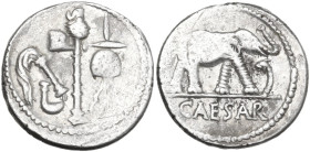 Caius Julius Caesar. Denarius, mint moving with Caesar, 49-48 BC. Obv. Pontifical emblems: culullus, aspergillum, axe and apex. Rev. Elephant advancin...