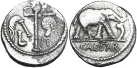 Caius Julius Caesar. Denarius, mint moving with Caesar, 49-48 BC. Obv. Pontifical emblems: culullus, aspergillum, axe and apex. Rev. Elephant advancin...
