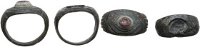Roman period. 2nd-3rd century AD. Lot of two (2) bronze rings. One with a lovely iridescent glass paste.