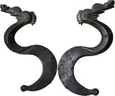Late Roman period, Balkans. Stylized bronze zoomorphic element in the shape of an S. 82 mm. lenght. Curious element, nice decoration. Dark patina.