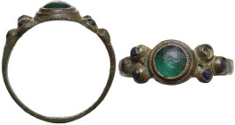Medieval or Renaissance period. Bronze ring with circular green stone in the center and three small blue glass pastes on each side. 19 mm. AE. Well pr...