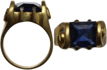 Post Reinassance, probably 18th century. Gilded ring decorated with two volutes, set with square blue glass gemstone. 16 mm. inner size.