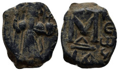 Arab-Byzantine, c. 660s-680s. Æ Fals (21mm, 4.4 g), Emperor standing facing, holding long cross and globus cruciger. R/ Cursive M; ANA to l., NEO to r...