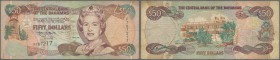 Bahamas: 50 Dollars 1996 Key Note P. 61 in used condition with folds and creases as well as light stain in paper, no repairs, original as taken from c...