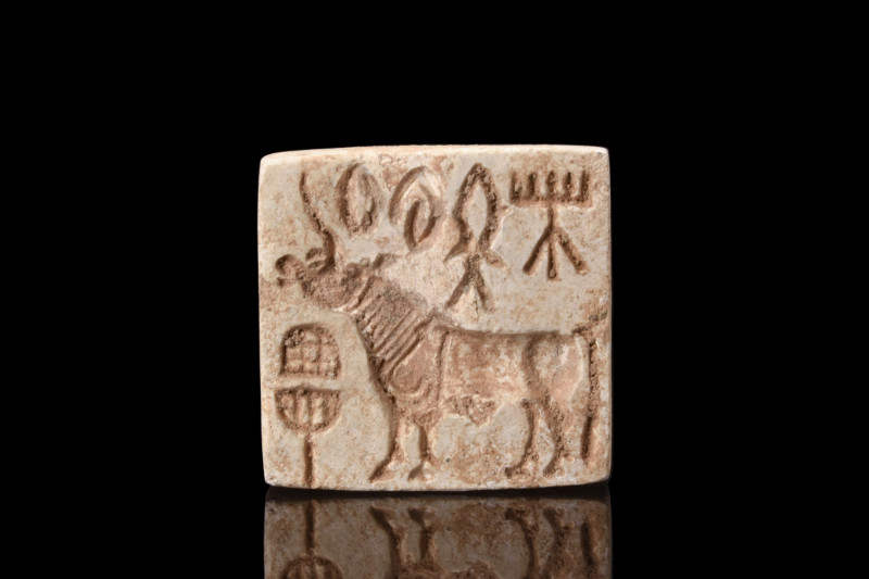 INDUS VALLEY STEATITE SEAL WITH BULL
Ca. 2500-1800 BC. 
A square seal in white...