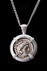 ALEXANDER III SILVER DRACHM IN SILVER PENDANT

Hellenistic Period, ca. 295–275 BC. 
A silver coin / drachm of Alexander the Great within a modern h...