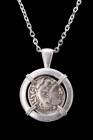 ALEXANDER III SILVER DRACHM IN SILVER PENDANT

Hellenistic Period, ca. 295–275 BC. 
A silver coin / drachm of Alexander the Great within a modern h...