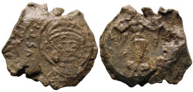 Byzantine Lead Seal (527-565 AD)
Obv: Nimbate, helmeted, and cuirassed facing bust of Justinian
Rev: Angel standing facing, holding two wreaths; to ...