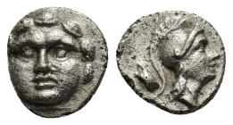 Pisidia, Selge. Ca. 350-300 B.C. AR obol (0.9 Gr. 9mm). 
Facing gorgoneion 
Rev. Helmeted head of Athena right; behind, astralagos.