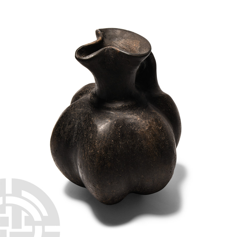 Late Roman Bucchero Jug
Circa 4th century A.D. The ribbed body with gusseted st...