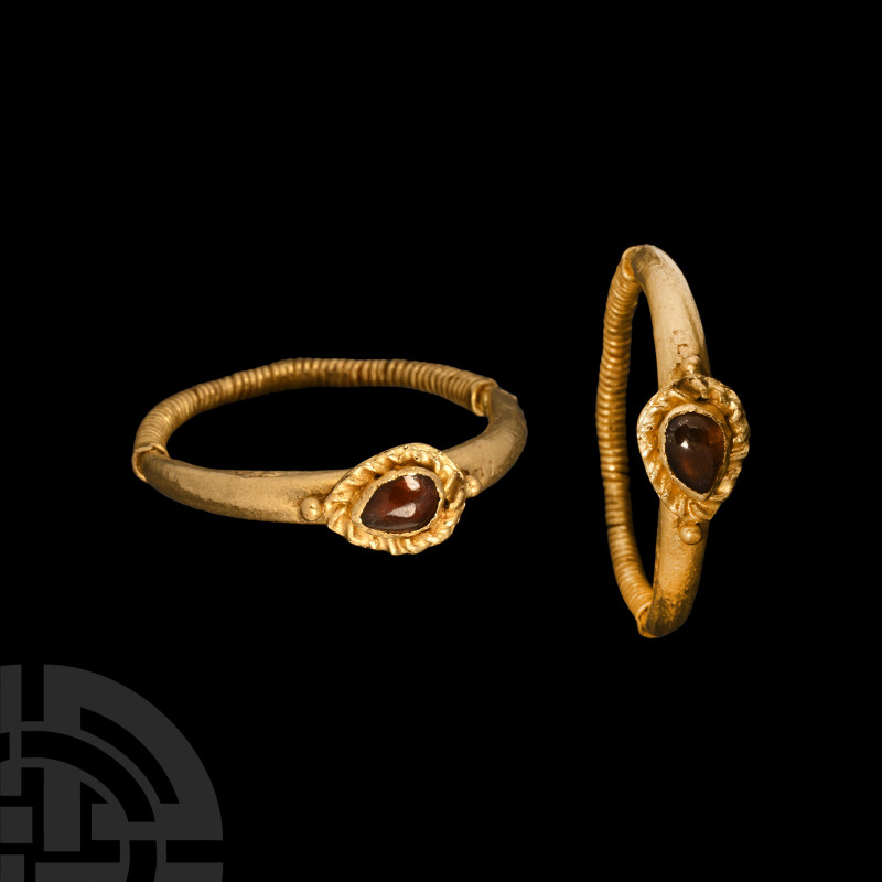 Western Asiatic Gold Ring with Garnet
Circa 2nd century A.D. Hollow-formed shan...