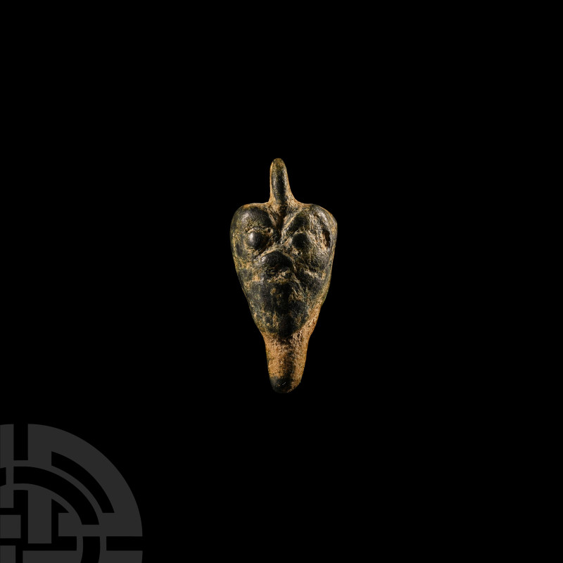 Phoenician Bronze Pazuzu Head Amulet
7th-6th century B.C. Piriform pendant with...