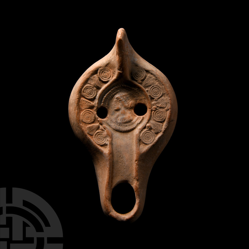 Roman Terracotta Oil Lamp
Circa 4th century A.D. With an integral thumb pad and...