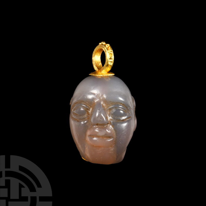 Western Asiatic Chalcedony Head with Gold Loop
1st millennium B.C. Carved in th...