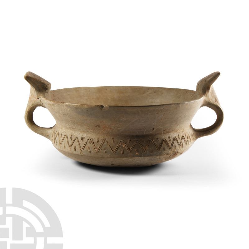 Luristan Double-Handled Terracotta Drinking Vessel
1st millennium B.C. Of squat...