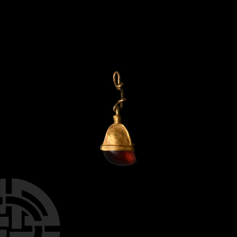 Viking Age Gold Elf Shot Pendant with Garnet
9th-12th century A.D. With a suspe...