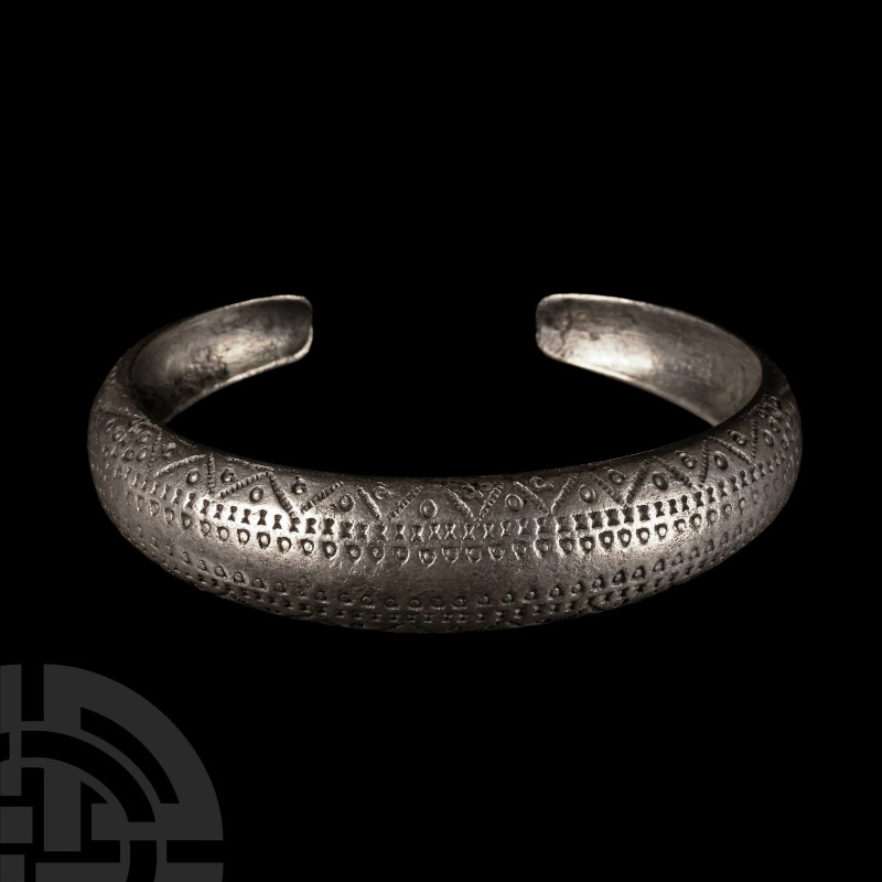 Viking Age Silver Stamp-Decorated Bracelet
9th-10th century A.D. Comprising a C...
