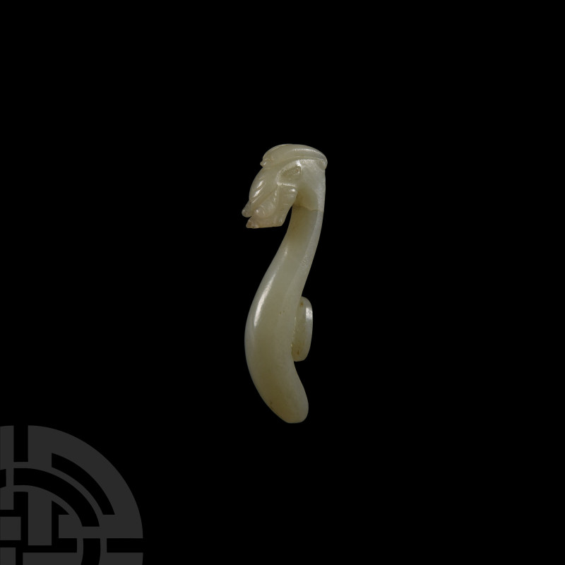 Chinese Han Style White Jade Garment Fastener
19th century A.D. With a roughly ...