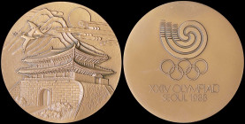 GREECE: SOUTH KOREA: Bronze participation medal of 1988 Seoul Summer Olympics. Seoul South Gate below mountainous cloud on obverse. The Seoul Olympic ...