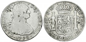 Carlos IV (1788-1808). 8 reales. 1792. México. FM. (Cal-685). Ag. 26,63 g. Pequeños resellos orientales. BC+. Est...40,00.
