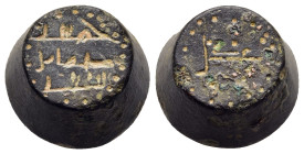 ISLAMIC WEIGHTS. Umayyads or Abbasids. Weight of 5 Dirhams or 1/2 Uqiya. Bronze.

A Barrel shaped Umayyad or Abbasid coin weight ; inscription in Kufi...