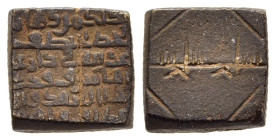 ISLAMIC WEIGHTS. Umayyads or Abbasids. Weight of 1 Dirham. Bronze.

A square shaped Umayyad or Abbasid coin weight ; inscription in Kufic on top and b...