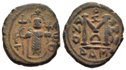 ISLAMIC. Umayyads. Arab- Byzantine types. AE Fals (ca. AD 660- 680). Damascus mint. 

Obv: Byzantine style standing emperor, holding long cross and gl...